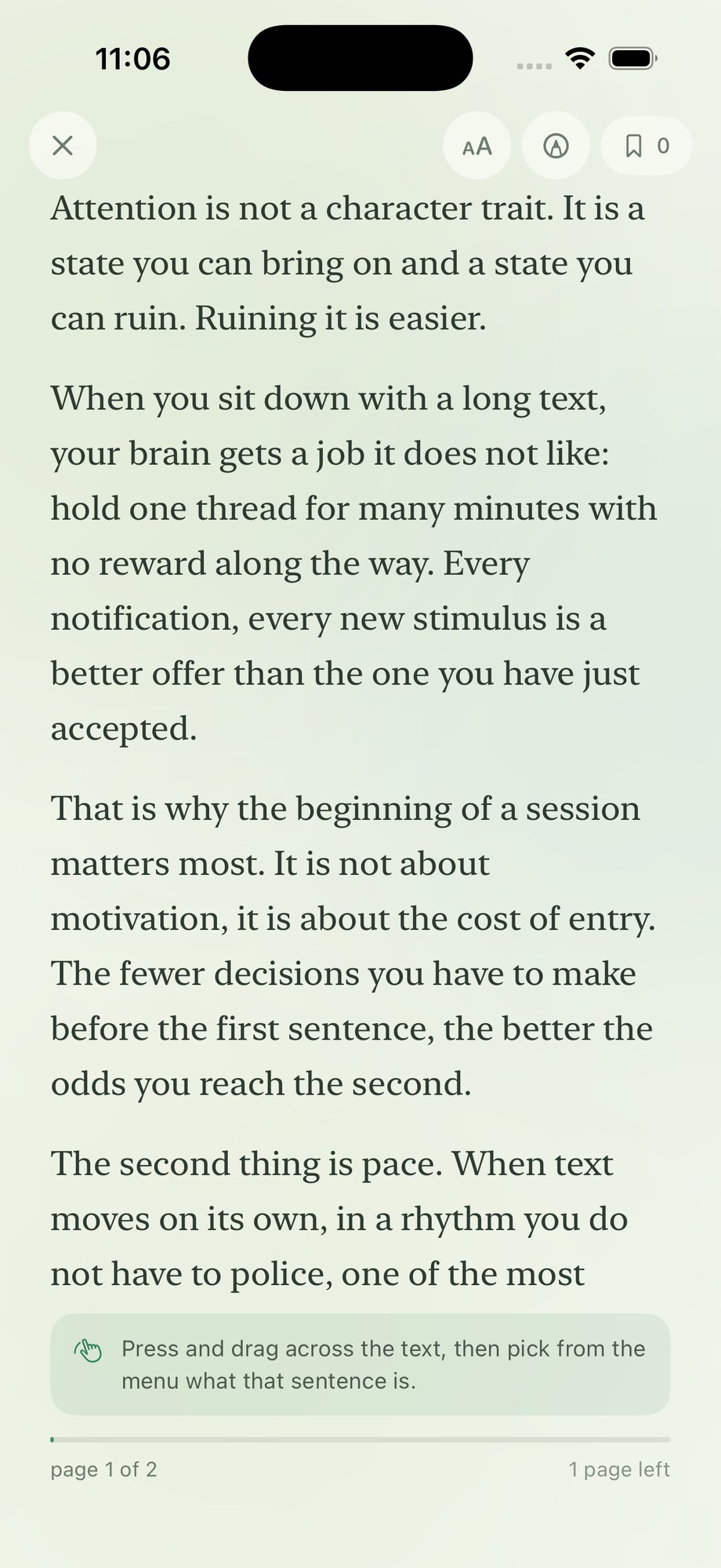 Traditional reading mode. A full page of text in a serif face, a hint at the bottom explaining that you press and drag across the text and then pick what that sentence is, and a footer reading “page 1 of 2, 1 page left”.