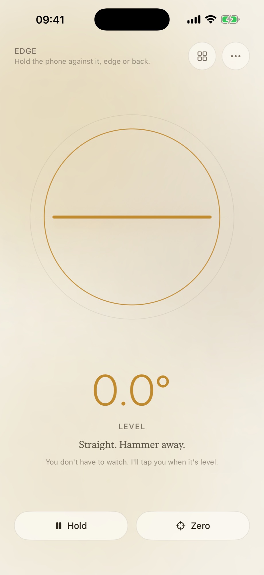 Edge mode in Nana’s Level. The header reads EDGE, with the line “Hold the phone against it, edge or back.” A single ochre line runs level across a large circle, the reading underneath says 0.0 degrees, and the sentence below it reads “Straight. Hammer away.”
